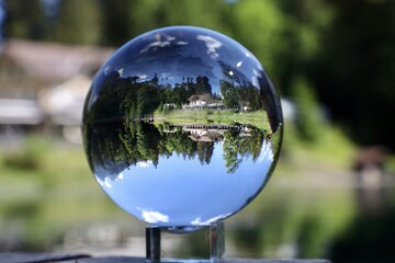 reflection in the lake trough a glas ball at blausee bern Switzerland 