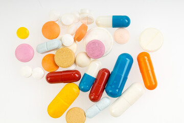 Set of different colorful pills and capsules isolated on white background.