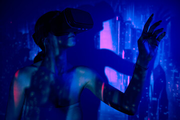 metaverse and technology, woman in virtual reality universe with vr glasses headset, futuristic...