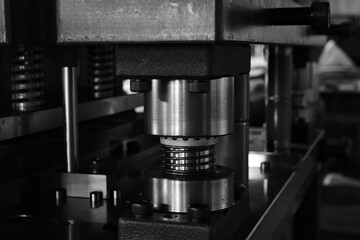 Sheet Metal Stamping Tool Die for Automotive Precision Parts on The Numerical Control Milling Machine Table. Tandem Stamping System. At a High Quality Technology Factory. Black and White Photography.