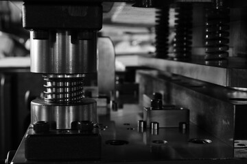 Sheet Metal Stamping Tool Die for Automotive Precision Parts on The Numerical Control Milling Machine Table. Tandem Stamping System. At a High Quality Technology Factory. Black and White Photography.
