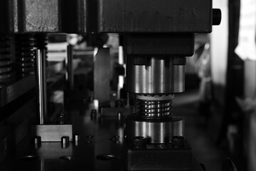 Sheet Metal Stamping Tool Die for Automotive Precision Parts on The Numerical Control Milling Machine Table. Tandem Stamping System. At a High Quality Technology Factory. Black and White Photography.