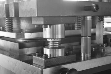 Sheet Metal Stamping Tool Die for Automotive Precision Parts on The Numerical Control Milling Machine Table. Tandem Stamping System. At a High Quality Technology Factory. Black and White Photography.