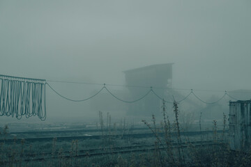 Railway factory in fog