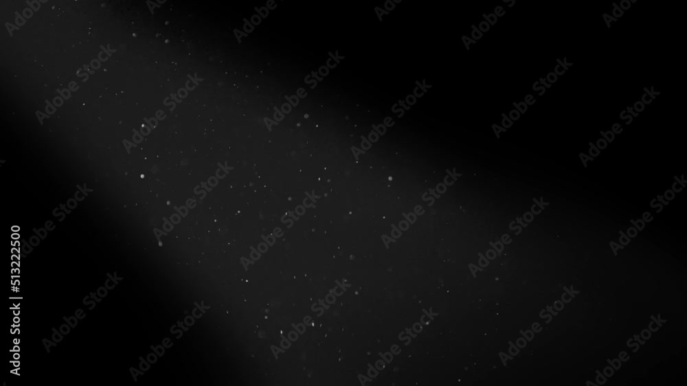 Wall mural dust particles in a light beam ray filmed with red camera in 4k in slow motion. elegant futuristic o