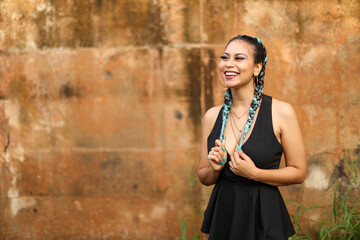 Latin Urban Playful Girl Smiling Playing with her Hair looking left