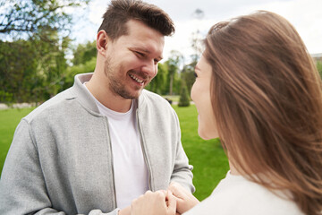 Fototapeta premium Happy couple in love holding hands on the street