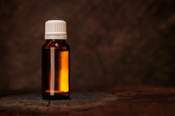 Small medicine bottle on old wood bottom, mockup. Natural healing product - mockup.