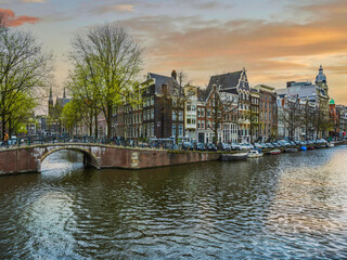 Canal bridge and colourful Dutch buildigs in Amsterdam, Netherlands