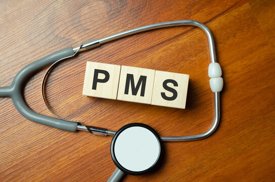 Medical and PMS, premenstrual syndrome symbol. Wooden cubes and blocks with words pms