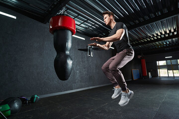 Serious strong athletic male doing plyometric exercise