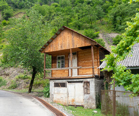 Fototapeta na wymiar Unusual house in nature. Wooden - concrete house. Reliable country house