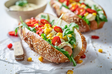 Spicy and delicious hot dogs with corn, sauce and chilli.