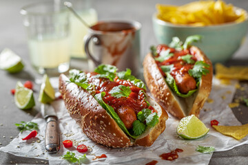 Unhealthy barbecue hot dogs with grilled sausage and sauce.