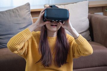 relieve stress on vacation Happy Asian woman relaxing at home playing VR 3D virtual reality game on vacation.