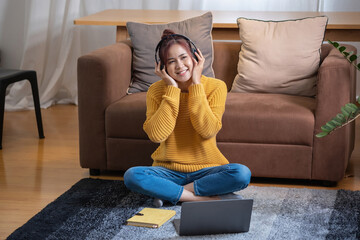 relax, de-stress, holiday, happy, Asian woman relaxing at home listening to music from smartphone and laptop happily.