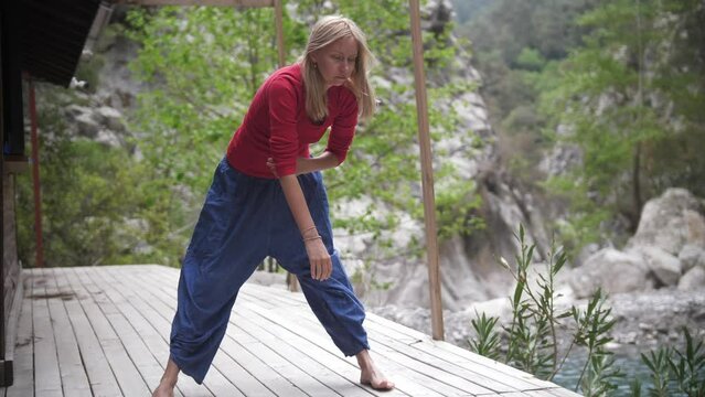 Yoga by the lake - spiritful woman attuned to meditation