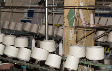 An old textile manufactory. Textile manufacturing. The work of textile processing machines.