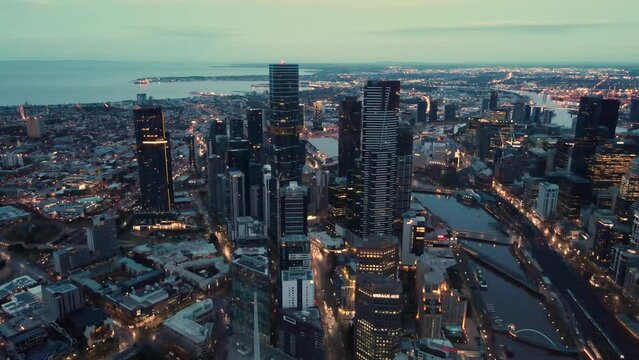 Beautiful aerial drone pullback reverse view of Melbourne City, Victoria, Australia above the Yarra River in the very early morning at dawn 