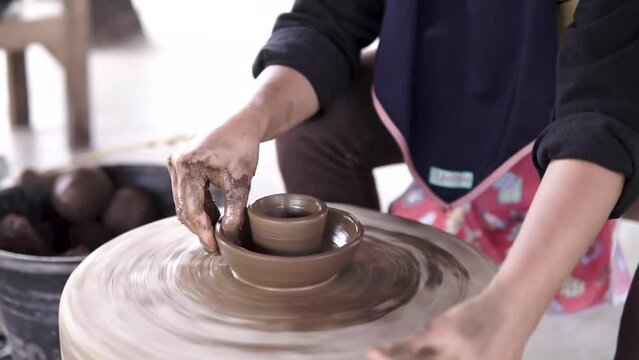 Craftsman who is making crafts with clay