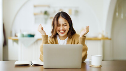 Excited asian female feeling euphoric celebrating online win success achievement result, young...