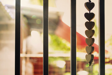 wooden hearts hanging at the window