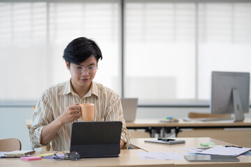 Cropped shot of a serious asian businessman thinking and concentrating typing on laptop at modern office. male laptop working concept