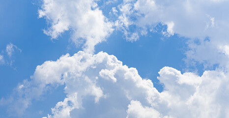 White and fluffy clouds on a blue sky
