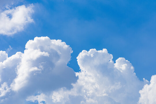 White and fluffy clouds on a blue sky