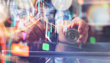 The man is holding a bitcoin coin. Businessman puts in bitcoin. The concept of buying bitcoins. Preservation. Cryptocurrency. Close-up. virtual money