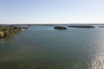 Orillia lake front green trees and lake blue skies drone shot 