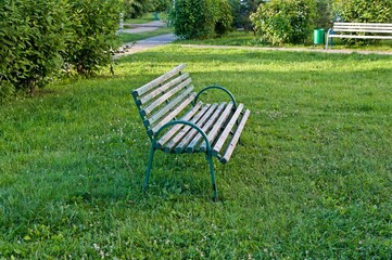 The bench stands on the grass of the lawn