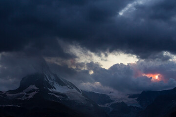 Beautiful storm cloudscape in the Swiss Alps in summer, with Matterhorn peak in the background