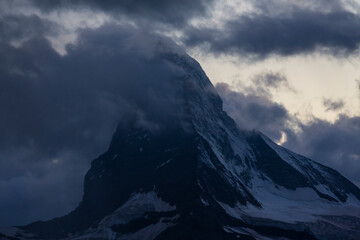 Fototapeta na wymiar Beautiful storm cloudscape in the Swiss Alps in summer, with Matterhorn peak in the background