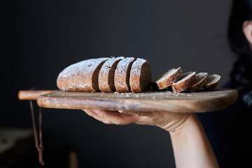 girl holding homemade rye bread