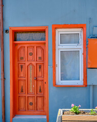 Fototapeta na wymiar Old wooden door, tiny concept wall and orange color door and window photo.