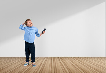 Fototapeta na wymiar Boy with phone in hand, thinking on white background. Copy space