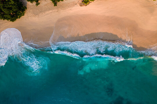 Aerial drone top view shot of white sand beach. Indian ocean shore. Copy space for text. Nature and travel background. Beautiful natural summer vacation travel concept.