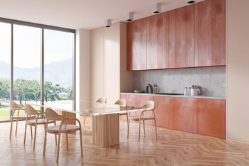 Modern kitchen interior with eating table and chairs, panoramic window