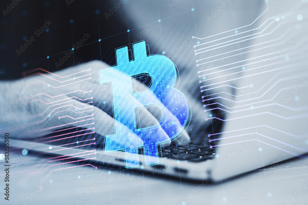 Poster close up of hands using laptop with glowing bitcoin hologram and lines on blurry background. e-comme