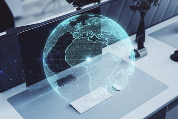 workplace with computer monitor, keyboard and creative glowing polygonal grid planet on blurry background. Globe, international map, communication, network earth and technology concept. 