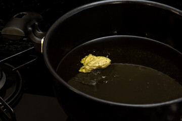 frying dough in cold oil, testing oil temperature