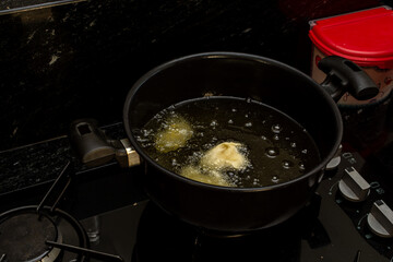 frying dough in oil, for a typical Brazilian recipe called 'bolinho de chuva'