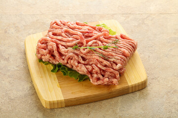 Raw minced pork meat over board