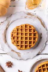 pumpkin waffles on a white wooden background