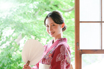 A beautiful Japanese woman wearing a yukata staring at the camera