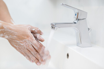 Hygiene. Cleaning Hands. Washing hands with soap under the faucet with water Pay dirt.