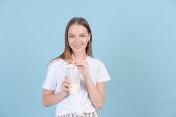 Follow me followers. Concept social influence. Close up studio photo portrait hipster carefree girl holding cocktail in her hand, wearing light clothes isolated blue pastel background