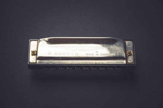 Vintage M. Hohner harmonica isolated on a black background, Paris, France
