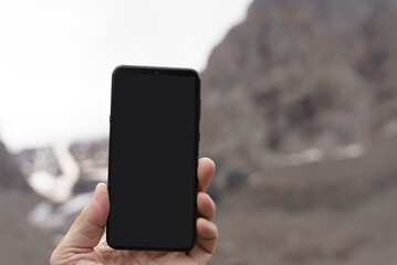 phone in hand in mountains